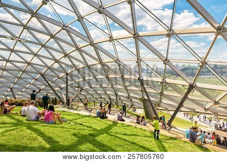Moscow - June 17, 2018: People Relax In Modern Amphitheater With Glass Roof In Zaryadye Park In Mosc