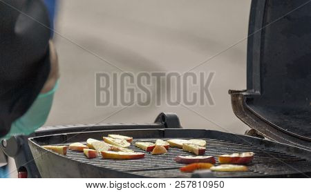 Chef Cooking Slices Of Apple On A Grille
