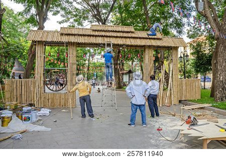 Phnom Penh, Cambodia - April 8, 2018: Workers  Making A Temporary Gate Out Of Bamboo Stems  In A Gar