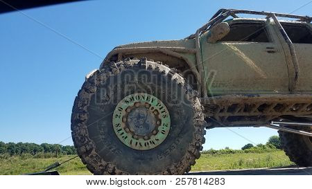 Money Pits 2.0 Off Road Truck Vehicle Truck Covered In Mud Being Towed Down The Highway In Summer, N