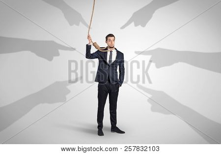 Young businessman trying to suicide with pointing hands concept