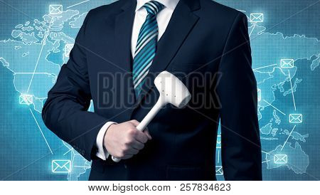Businessman holding tool with global map graphic on the background