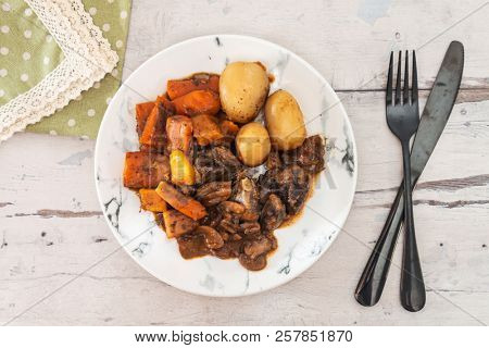 Beef meat stewed with potatoes-Traditional French cuisine Beef Bourguignon potatoes carrots in persillade