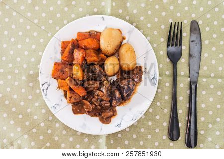 Beef meat stewed with potatoes-Traditional French cuisine Beef Bourguignon potatoes carrots in persillade