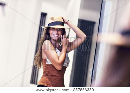 Beautiful woman thinking what to dress in walk-in closet