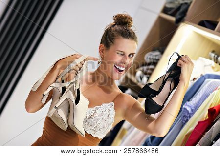 Beautiful woman thinking what to dress in walk-in closet
