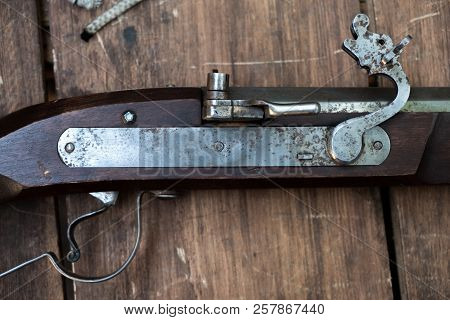 Closeup Of Antique Firearm. Close-up. On Wooden Background.