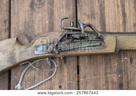 Closeup Of Antique Firearm. Close-up. On Wooden Background