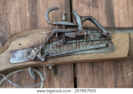 Closeup Of Antique Firearm. Close-up. On Wooden Background