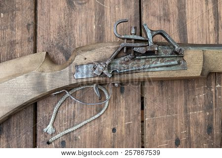 Closeup Of Antique Firearm. Close-up. On Wooden Background.