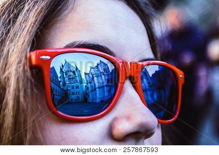Germany, Fussen - October 31, 2017: Famous Landmark Neuschwanstein Castle Is Reflected In The Red Su