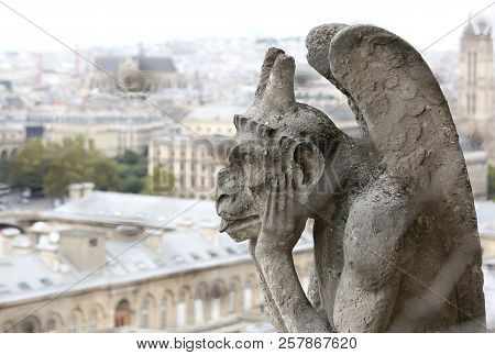 Thinking Figure Called Chimera Or Grotesque With Wings In Paris From Bell Tower Of Basilica Of Notre