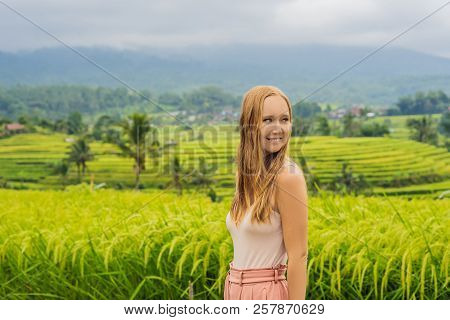 Young Woman Traveler On Beautiful Jatiluwih Rice Terraces Against The Background Of Famous Volcanoes