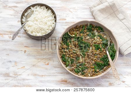 Stewed Kale Lentils With Onions And Garlic, Boiled Rice. On A Light Background, Selective Focus, Fre