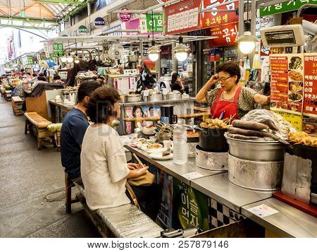 Seoul, South Korea - June 21, 2017: People Eating Tasty Food And Drink At Gwangjang Market In Seoul.