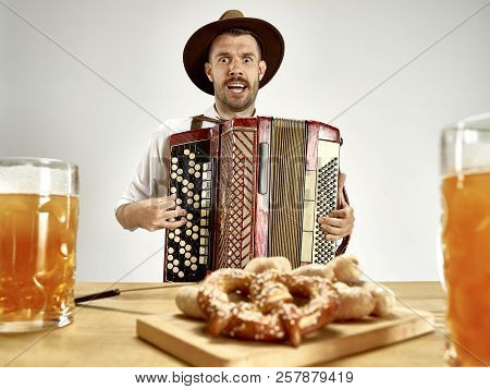 Man In Traditional Bavarian Clothes Playing Accordion. Germany, Bavaria, Upper Bavaria. The Young Ha