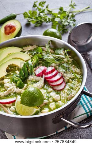Chicken Pozole Verde In A Metal Casserole - Mexican Stew Filled With Shredded Chicken And Hominy In 