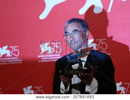 Pema Tseden poses with Orizzonti Award for Best Screenplay Award forJinpa at the Winners Photocall during the 75th Venice Film Festival on September 8, 2018 in Venice, Italy.