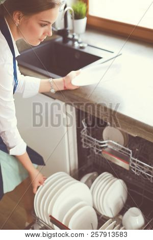 Dishwasher. Young woman in the Kitchen doing Housework. Wash-up