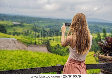 Young Woman Traveler On Beautiful Jatiluwih Rice Terraces Against The Background Of Famous Volcanoes
