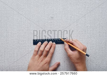 The Builder Marks On The Wall With A Ruler And Pencil The Dimensions For The Hole.