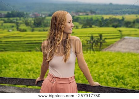 Young Woman Traveler On Beautiful Jatiluwih Rice Terraces Against The Background Of Famous Volcanoes