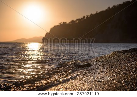 Beautiful Sea Wave Washes Pebbles On The Shore In Blur.