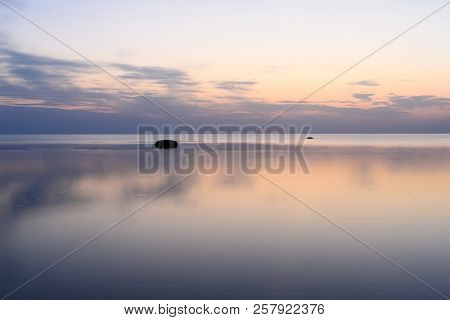 The Sky Is Reflected In The Sea At Sunset On A Long Exposure.