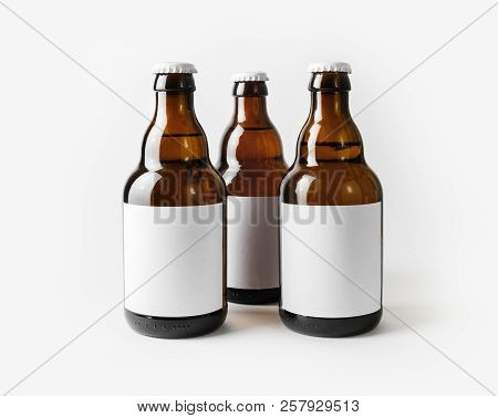 Three Beer Bottles With Blank Labels. Template For Placing Your Design.