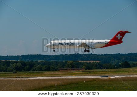 Zurich, Switzerland - July 19, 2018: Helvetic Swiss airlines airplane preparing for landing at day time in Zurich nternational airport