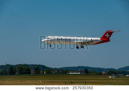 Zurich, Switzerland - July 19, 2018: Helvetic Swiss airlines airplane preparing for landing at day time in Zurich nternational airport