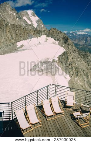 Empty Chaise Lounges On The Terrace Punta Helbronner, Top View, Mountain Vacation