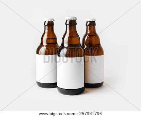 Three Glass Brown Beer Bottles With With Blank Labels.