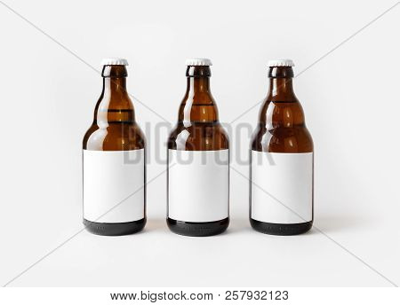 Three Brown Beer Bottles With Blank Labels.