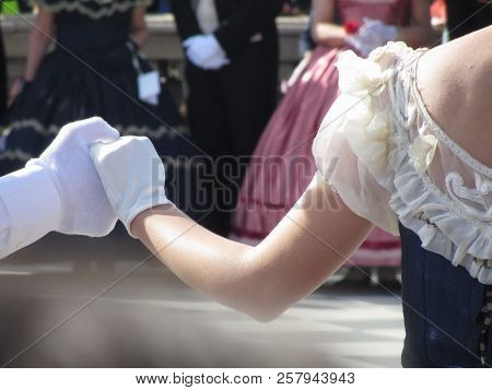 Close Up Of Couple Hands In White Gloves During Historical Dance . Loveliness And Prettiness Couple 