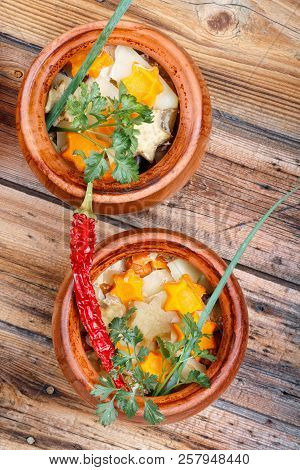 Traditional Rustic Home  Gulyas, With Raw Vegetables And Spices In Clay Pots On  Old Vintage Wooden 