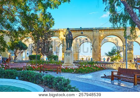 Valletta, Malta - June 17, 2018: The Lord Strickland Statue Among The Grenery, Flower Beds And Bench