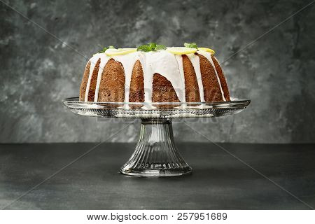 Whole Lemon Cream Cheese Bundt Cake With Slices Of Fresh Lemons And Mint On Top. Extreme Shallow Dep
