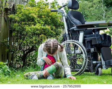 Disability A Disabled Child Relaxing In The Garden