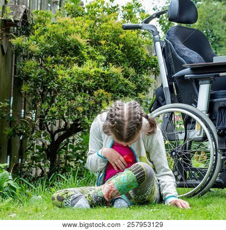 Disability A Disabled Child Relaxing In The Garden