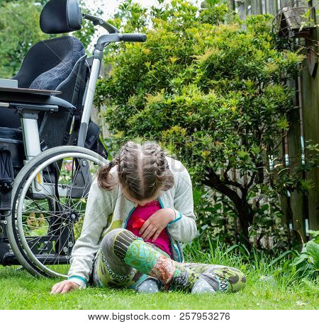 Disability A Disabled Child Relaxing In The Garden