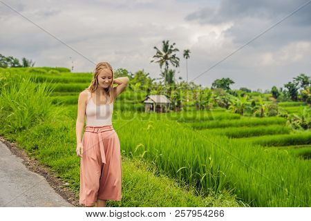 Young Woman Traveler On Beautiful Jatiluwih Rice Terraces Against The Background Of Famous Volcanoes