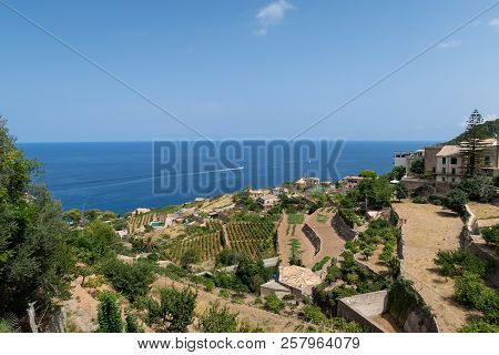 Historic Village Of Banyalbufar On Mallorca, Spain Against Blue Sky And Sea On Sunny Summer Day