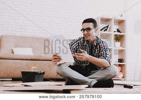 Young Man Assembling Wooden Bookshelf At Home. Wooden Bookcase. Selfmade Furniture. Man And Hobby. W