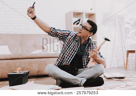 Young Man Assembling Wooden Bookshelf At Home. Wooden Bookcase. Selfmade Furniture. Man And Hobby. W