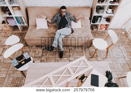 Young Man Assembling Wooden Bookshelf At Home. Wooden Bookcase. Selfmade Furniture. Man And Hobby. W