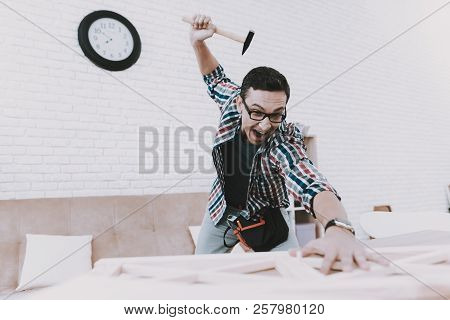 Young Man Assembling Wooden Bookshelf At Home. Wooden Bookcase. Selfmade Furniture. Man And Hobby. W