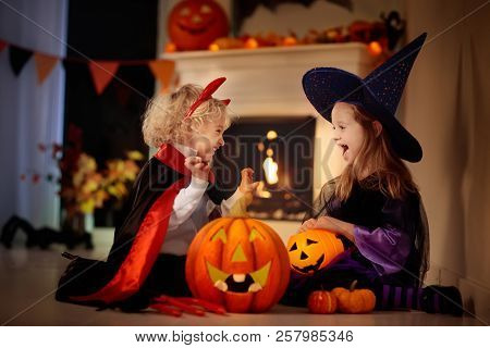 Kids In Witch Costume On Halloween Trick Or Treat