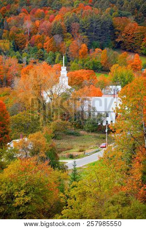 Small church in Topsham village in Vermont in the middle of fall foliage