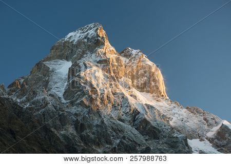 Top Ushba. Caucasus Mountains. Peak in the light of the rising sun.  Samegrelo-zemo Svanetii, Georgia. Art processing of photos, color toning